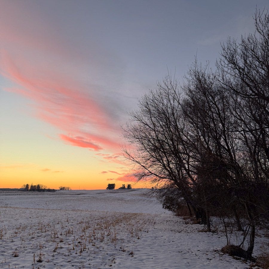 a colorful sunset over a snowy field