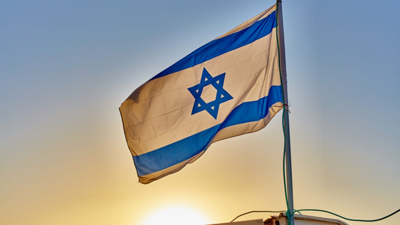 Israel's flag in front of the setting sun. Israel's flag in front of the setting sun.