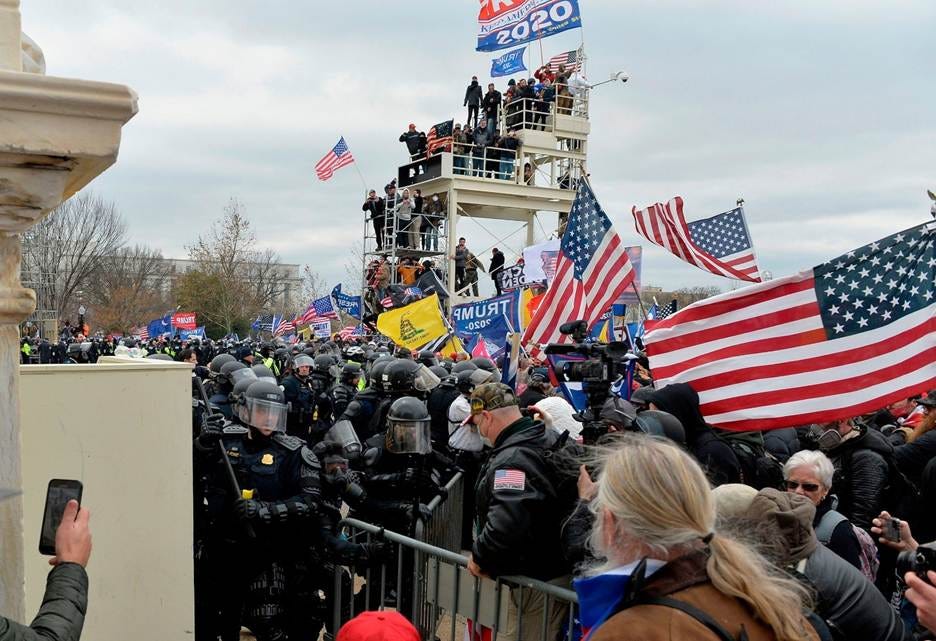 A crowd of people in riot gear

AI-generated content may be incorrect.