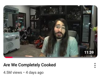 A person with long hair and beard sitting in a room with a white machine and black shelves

AI-generated content may be incorrect.