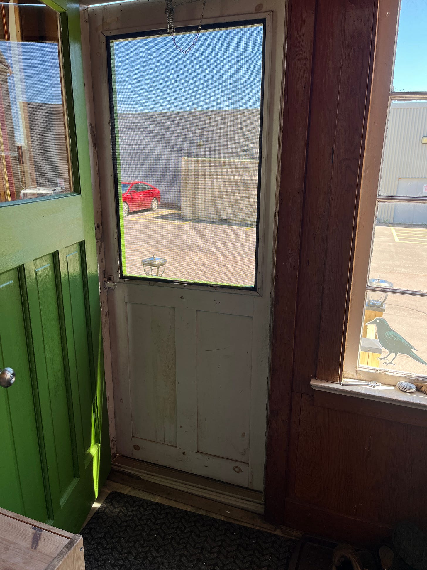 Looking through the wooden screen door at the front of my house. 