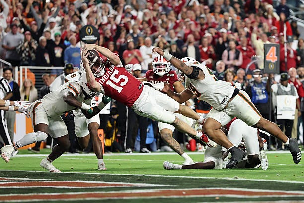 Fernando Mendoza of the Indiana Hoosiers dives for a fourth quarter touchdown against the Miami Hurricanes in the 2026 College Football Playoff... Fernando Mendoza of the Indiana Hoosiers dives for a fourth quarter touchdown against the Miami Hurricanes in the 2026 College Football Playoff...
