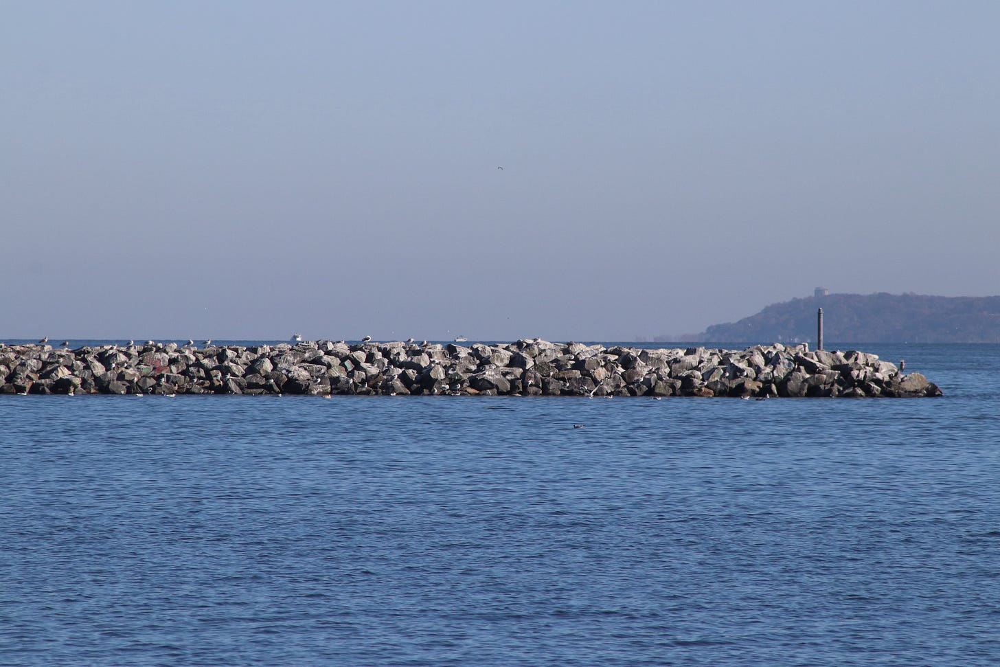 a breakwater is shown in Rarity Bay off the shore of Staten Island, NY