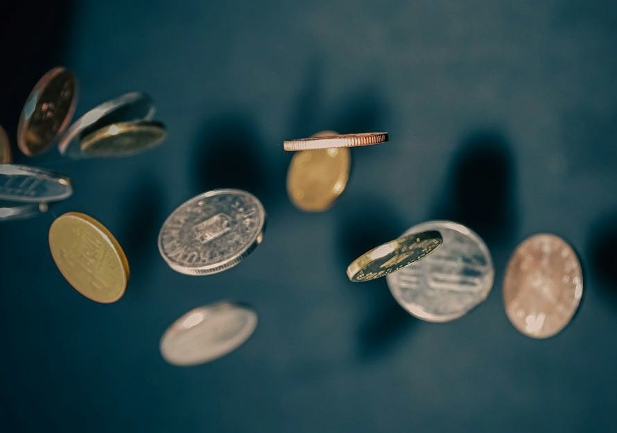 a bunch of coins falling off of a table