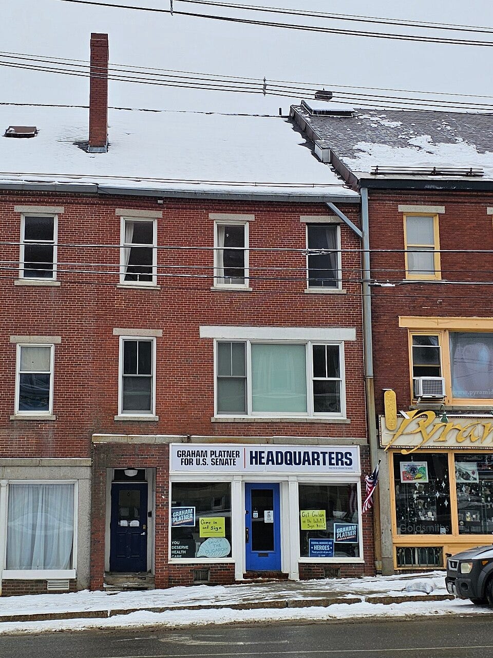 Platner's campaign hq in Ellsworth ME, in winter; it's a nondescript storefront in an attached building Platner's campaign hq in Ellsworth ME, in winter; it's a nondescript storefront in an attached building