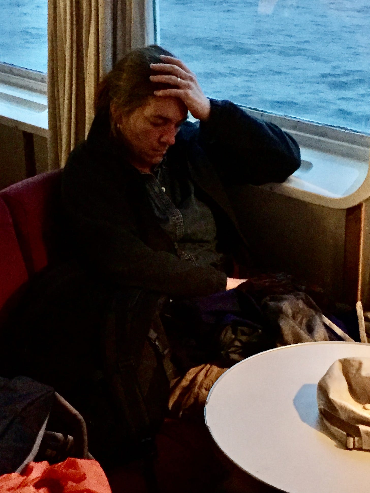 Photo of me with my eyes closed on a ferry in Iceland.