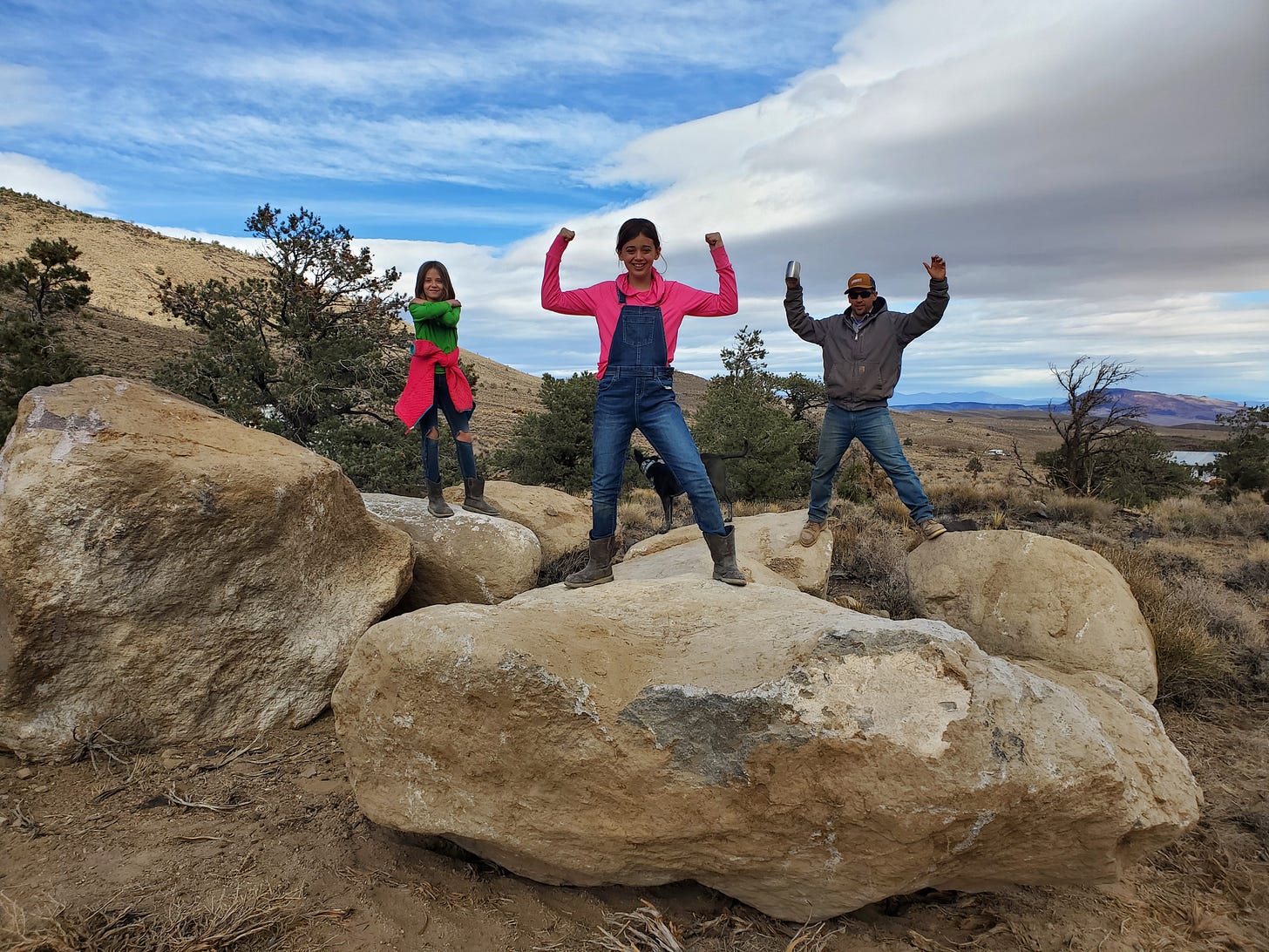 L, C, and Eric standing on rocks the size Mini Coopers