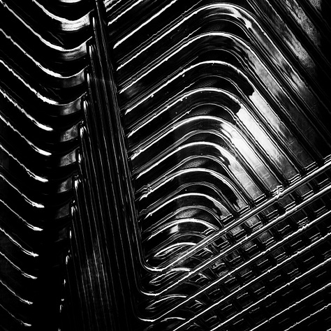 Six black and white square images that have caught my eye, left to right top row - a stack of chairs, a stack of roofing tiles, the open window in my room, an old tyre leaning against a tree with flwoers growing around it, the door of an old wooden barn and a pipe with a curve to a tap