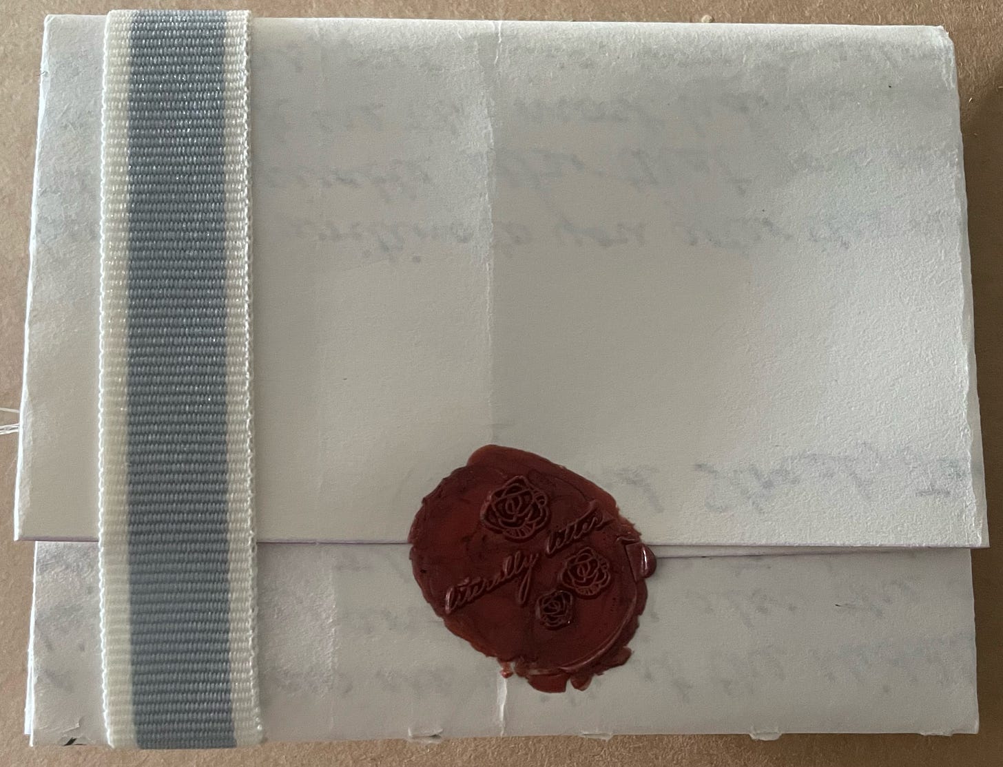 Unopened letter turned over to see its seal on the back.