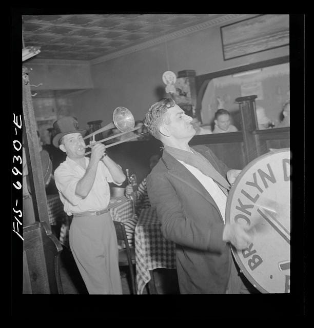 Italian American musicians in Brooklyn gather inside a bar after playing at a neighborhood flag-raising ceremony in 1942. Italian American musicians in Brooklyn gather inside a bar after playing at a neighborhood flag-raising ceremony in 1942.