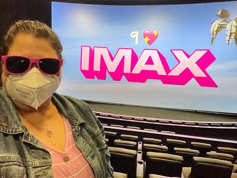 Photos of a girl dressed in pink at the movies seeing Barbie in IMAX