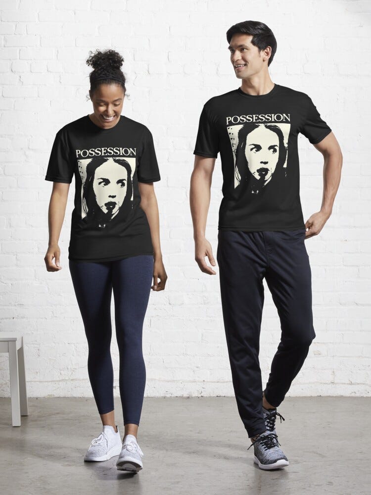 Two models both wearing a black t-shirt with a bloody and deranged female face on it, the header reads "Possession"