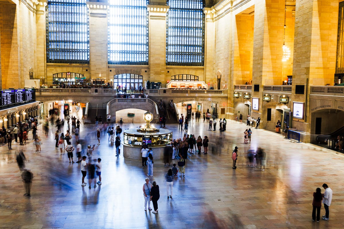 Long exposure photo at Grand Central showing increased motion blur of commuters under bright hall lighting Long exposure photo at Grand Central showing increased motion blur of commuters under bright hall lighting