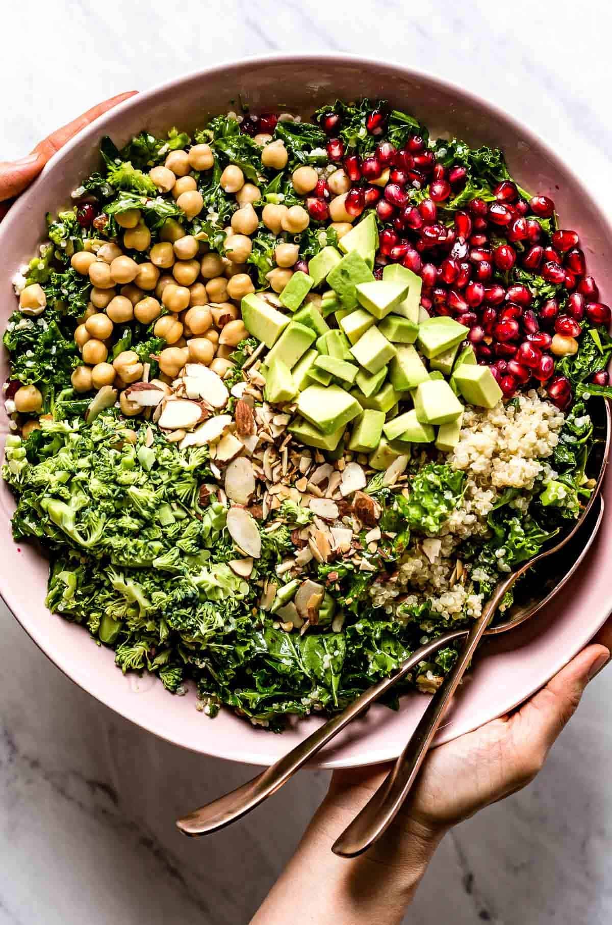 Quinoa and Kale salad served in a bowl by a person from the top view. Quinoa and Kale salad served in a bowl by a person from the top view.
