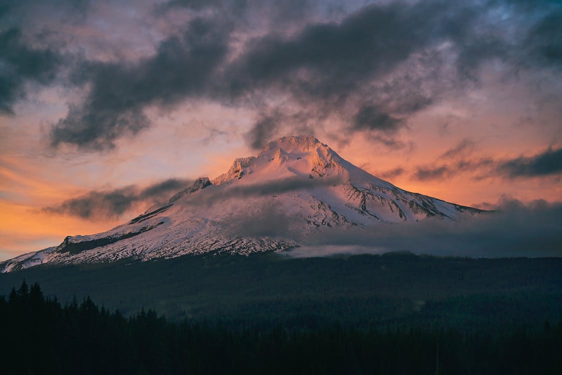 Free Snow Capped Mountain Under Gray Clouds Stock Photo
