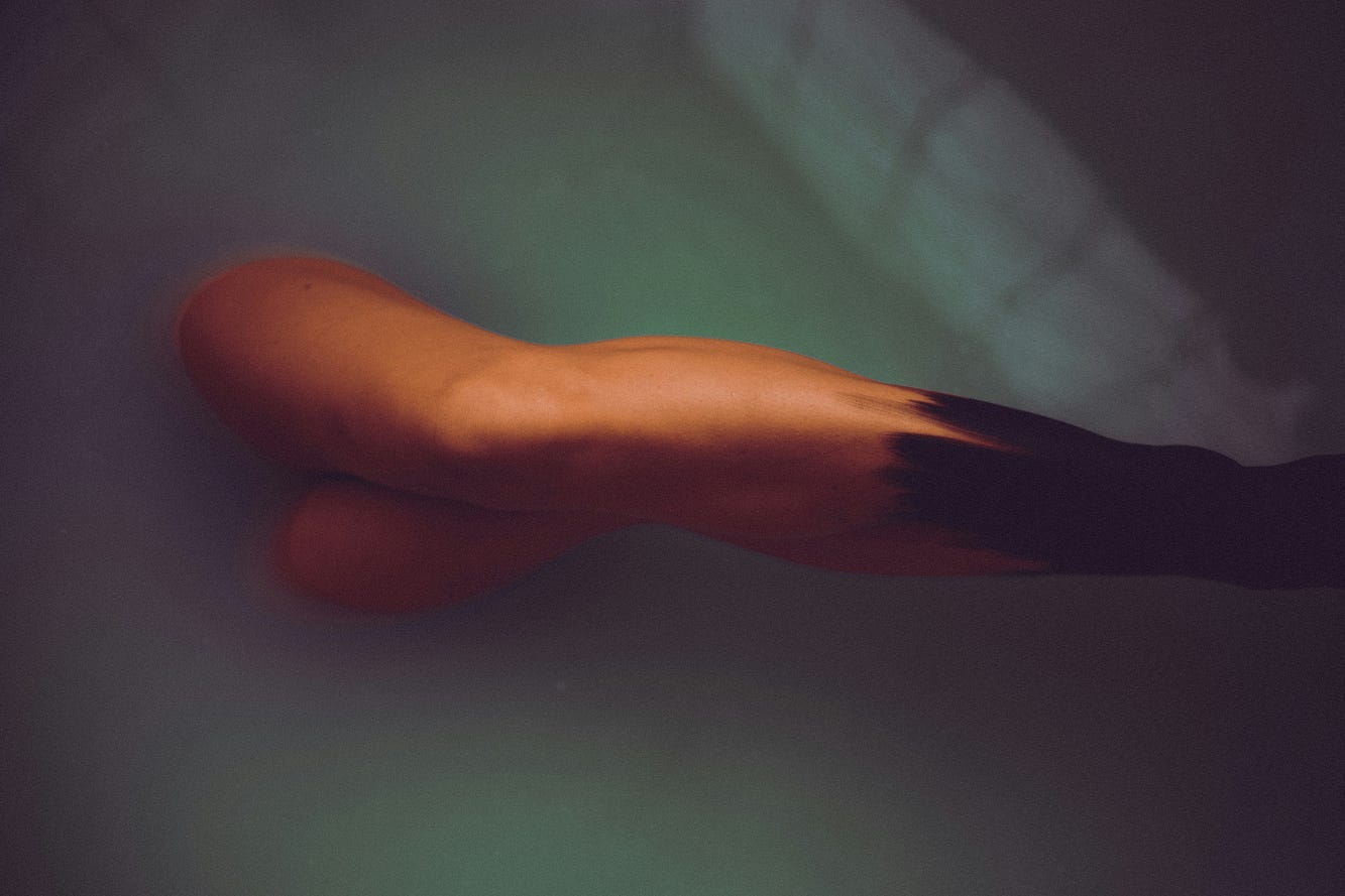 A pair of legs poking out of the water. A pair of legs poking out of the water.