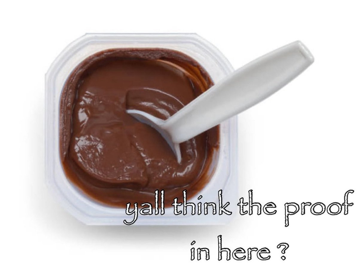 A plastic container of chocolate pudding with a white plastic spoon inserted into it. The pudding is smooth and brown, filling the container.