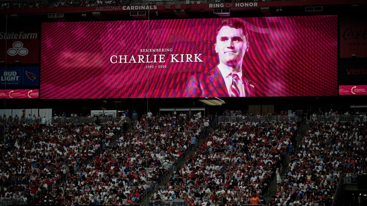 A photo of the conservative activist Charlie Kirk is seen on a large screen during a memorial for Kirk at State Farm Stadium in Glendale, Ariz. A photo of the conservative activist Charlie Kirk is seen on a large screen during a memorial for Kirk at State Farm Stadium in Glendale, Ariz.