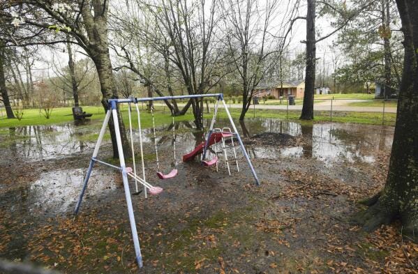 FILE - Heavy rains flood the front yard of Lowndes County resident Charlie Mae Holcombe, Feb. 21, 2019, in Hayneville, Ala. The U.S. Department of Justice on Thursday, May 4, 2023, said an environmental justice probe found Alabama engaged in a pattern of inaction and neglect regarding the risks of raw sewage for residents in the impoverished Alabama county and announced a settlement agreement with the state. (AP Photo/Julie Bennett, File)