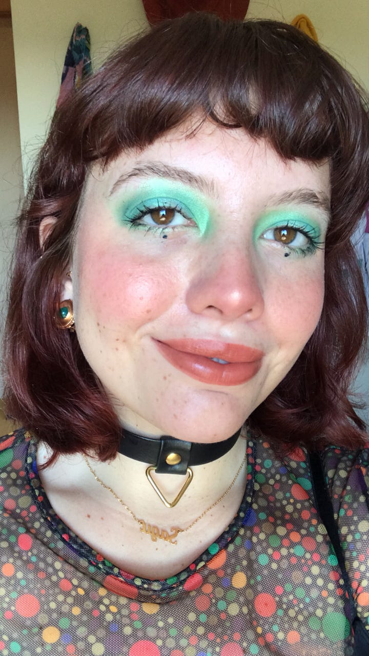 Left: Larissa in a multicolored pastel tutu-esque skirt, light pink t shirt, and orange sunglasses. Right: Larissa in a dramatic seafoam eye look and black choker..