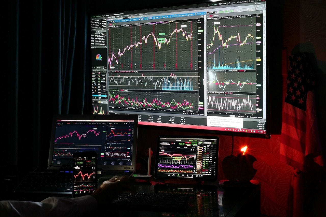 Multiple computer screens with financial data displays Multiple computer screens with financial data displays