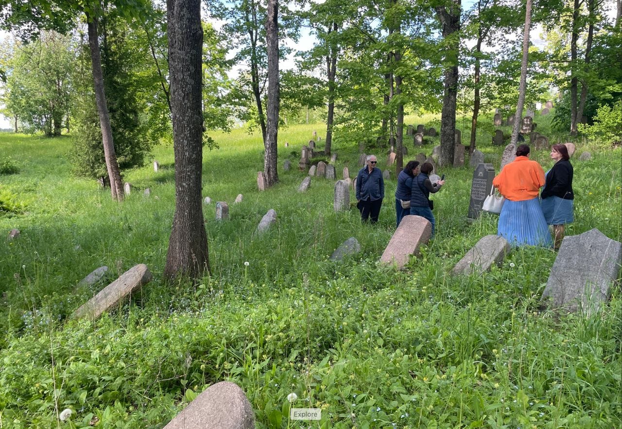 Searching for family graves in the Jewish cemetery at Ludza. Despite plot numbers, the heavily overgrown cemetery made locating them difficult.