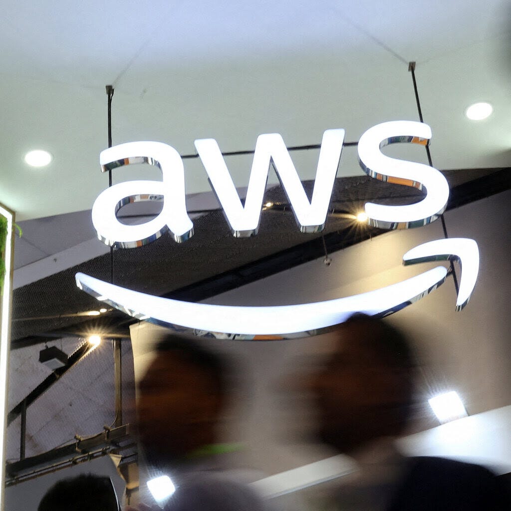 A large sign with the letters AWS and the Amazon arrow beneath it. 