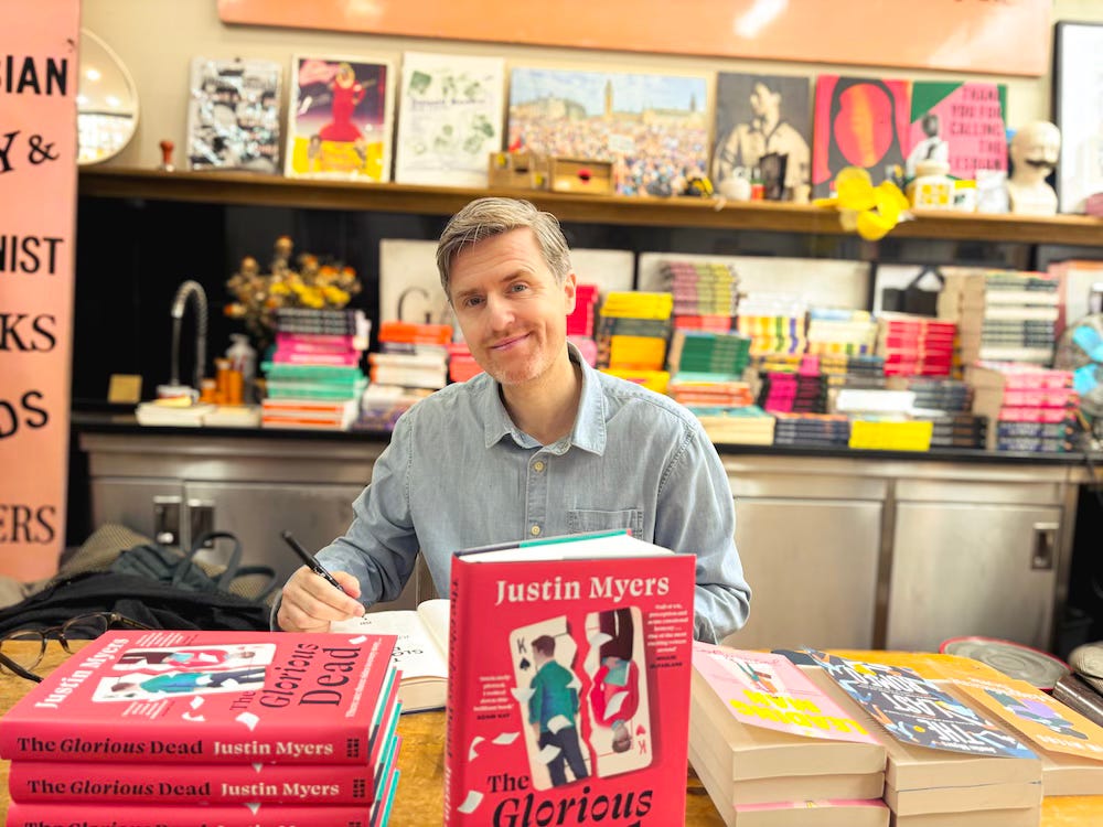 Justin in Gays The Word signing books