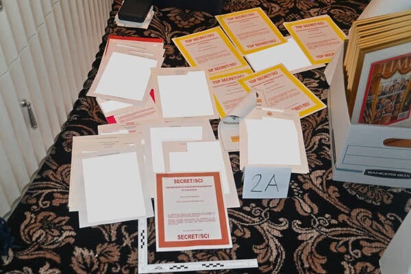 The Justice Department included a photo of documents seized from former President Donald J. Trump’s Florida home in its court filing.
