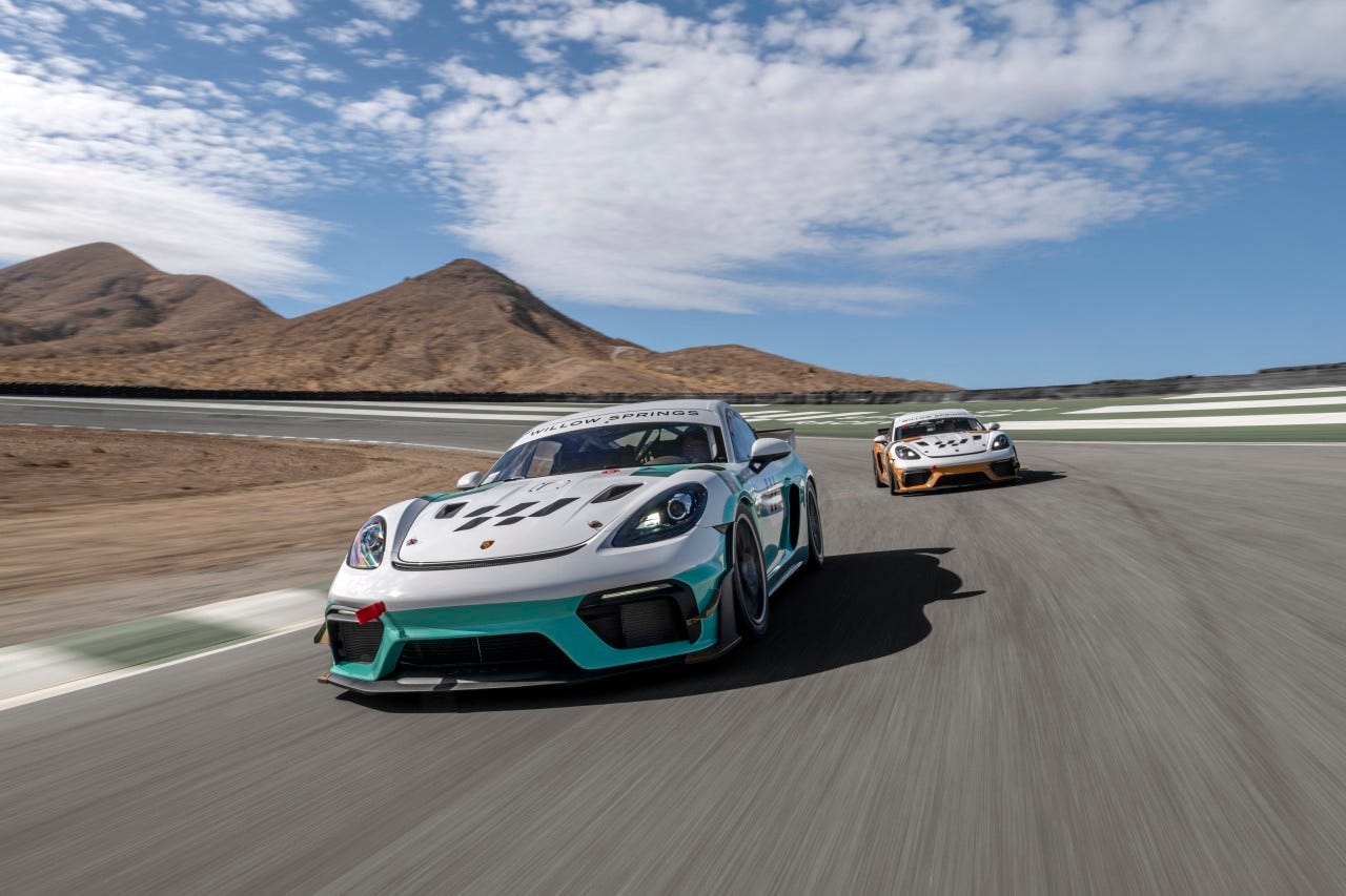 Two Porsche Cayman GT4RS Clubsports racing on the track at Willow Springs.