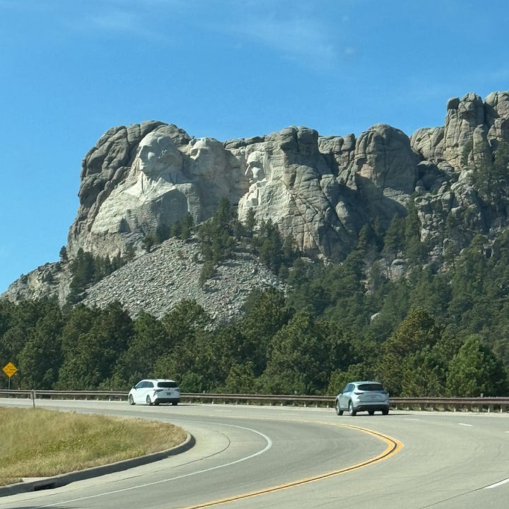 Photos of a harbor in Cleveland, downtown Chicago, Mt. Rushmore and Omaha, NE