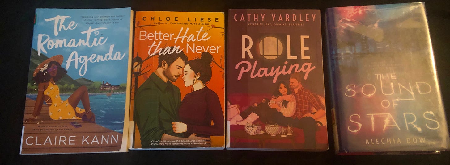 A photo of four books: The Romantic Agenda by Claire Kann; Better Hate Than Never by Chloe Liese; Role Playing by Cathy Yardley; and The Sound of Stars by Alechia Dow