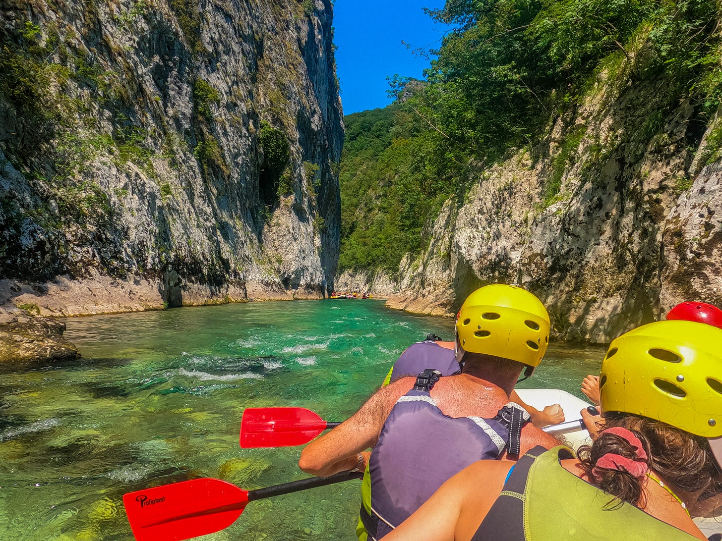 Rafters paddling along the gorgeous green waters of the Neretva. Rafters paddling along the gorgeous green waters of the Neretva.
