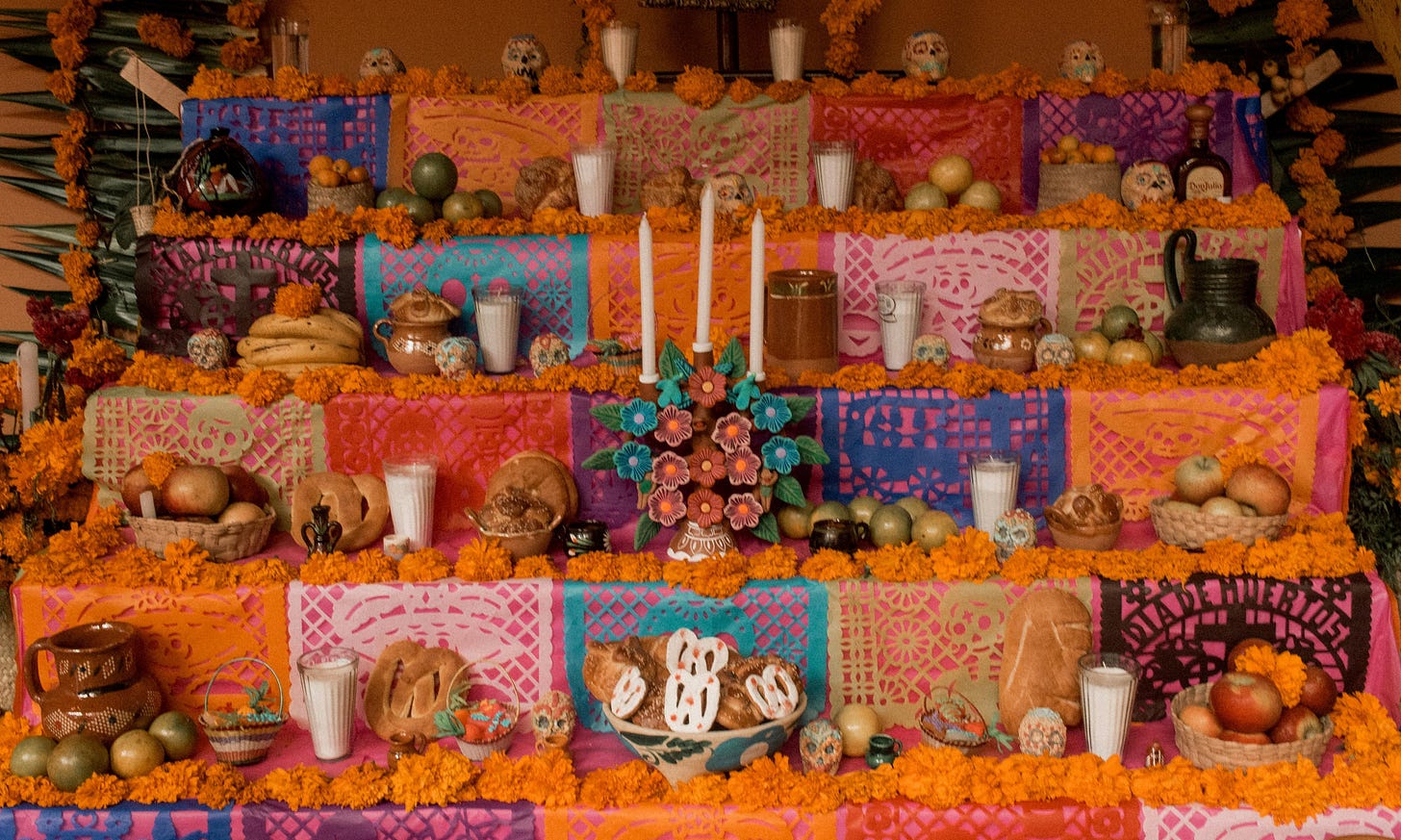 Flowers and fruit cover this ofrenda in Mexico during Día de los Muertos 