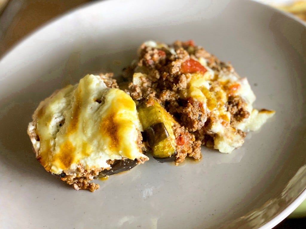 Serving of moussaka on a grey plate