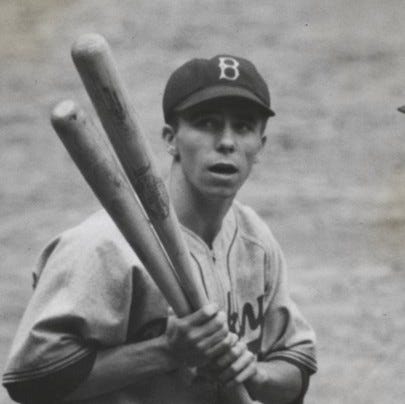 Pee Wee Reese and Joe Medwick holding bats.