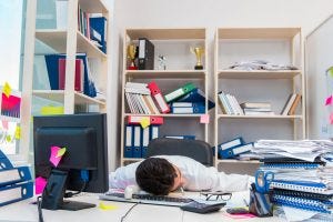 Businessman working in the office with piles of books and papers Image ID : 87215213 Copyright : Elnur Amikishiyev