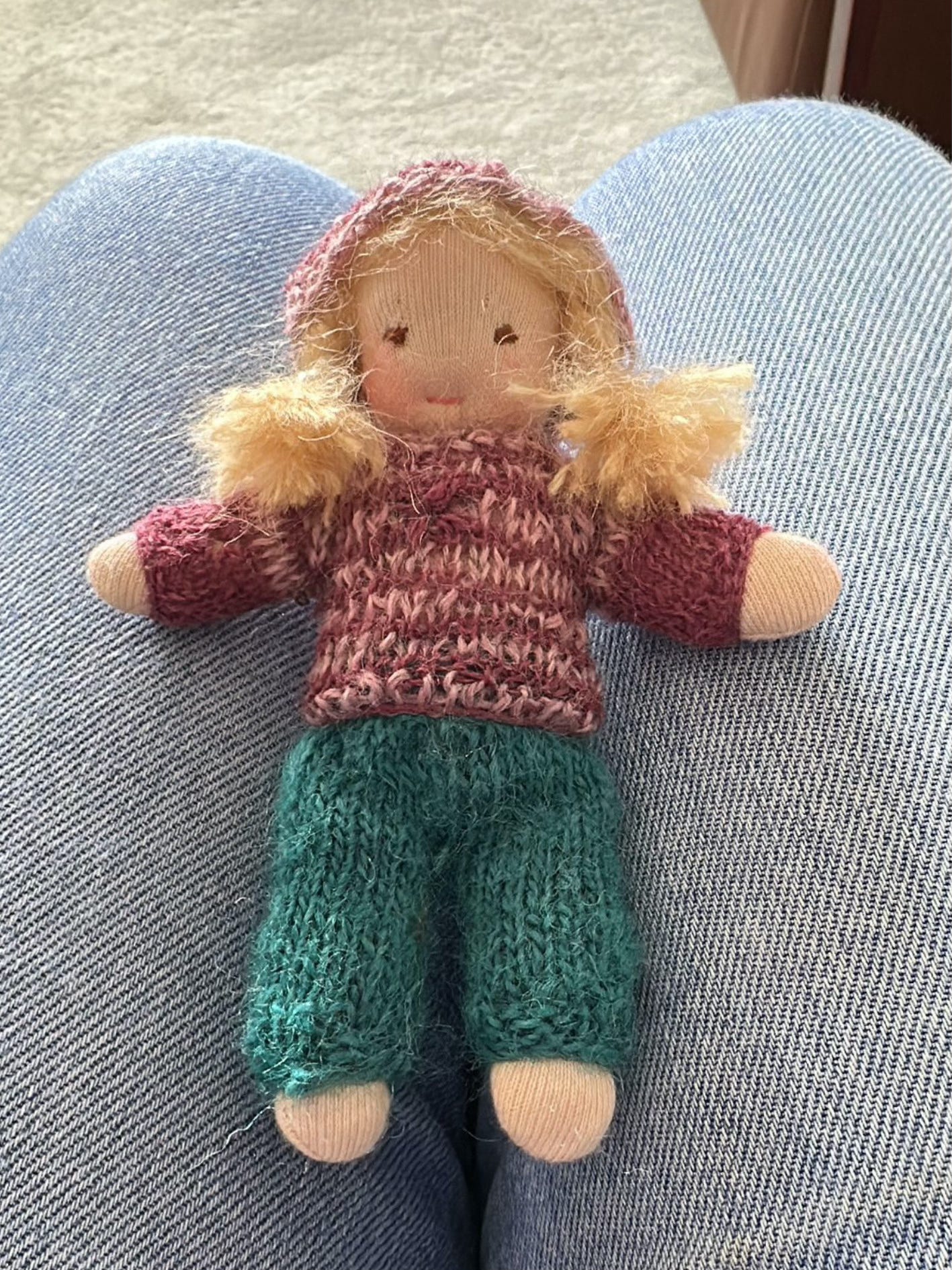 Photo of a pocket-sized natural fibre doll made with a kit designed by Illustrator an Doll-maker Hannah Sanguinetti 