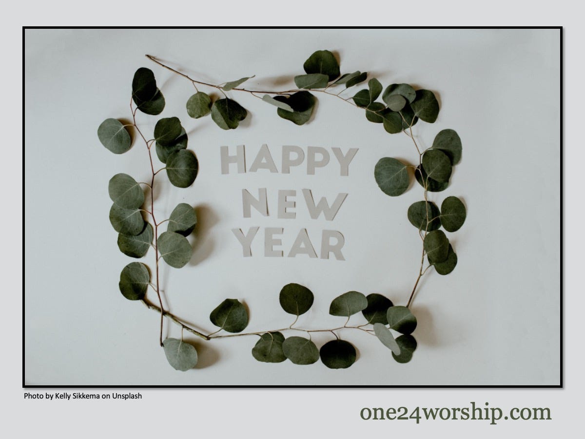 Image of Happy New Year letters surrounded by Eucalyptus branches.