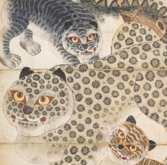 A group of tigers on a piece of paper

Description automatically generated