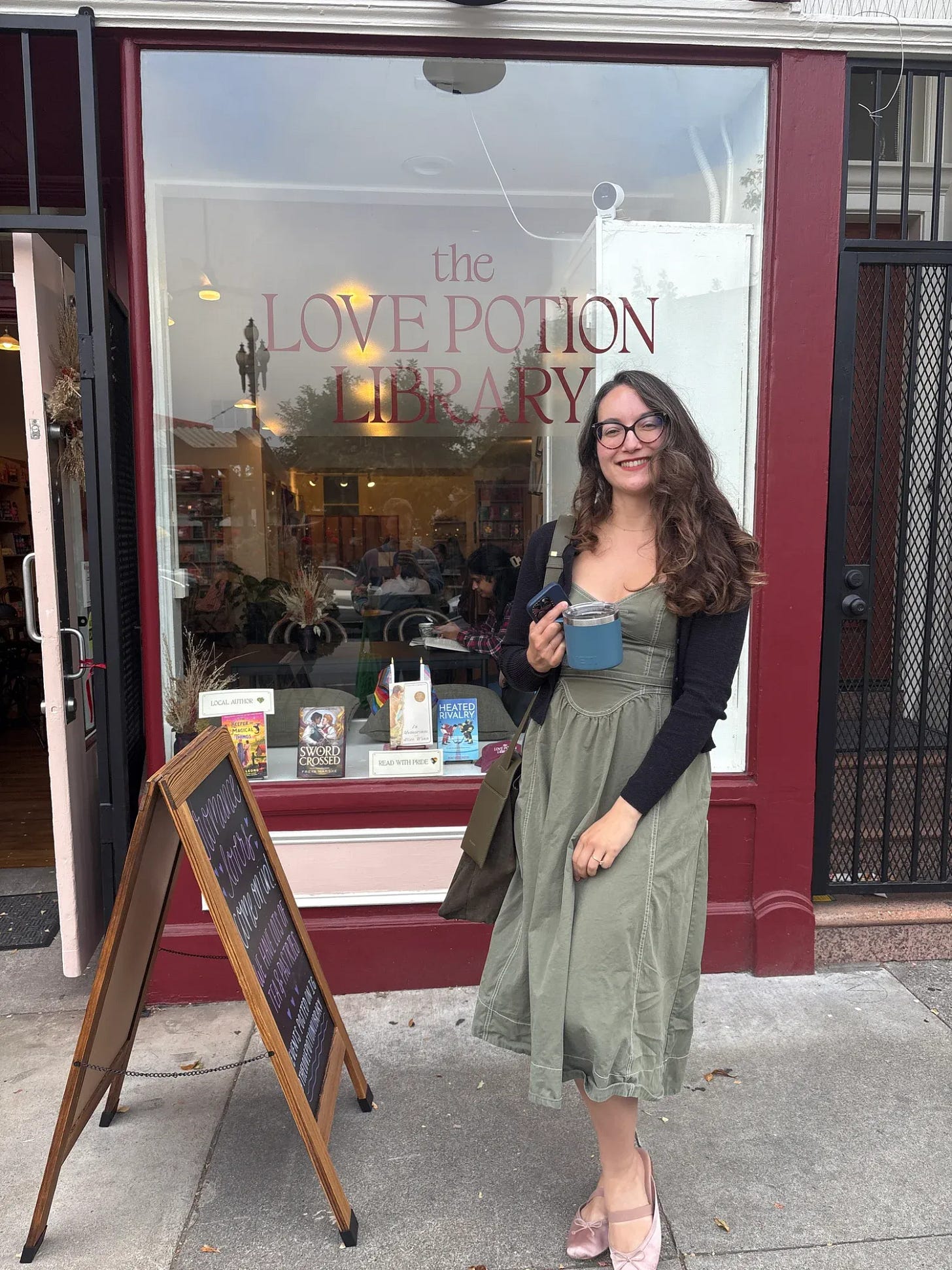 Amy Suto standing outside The Love Potion Library, a romance bookstore in San Francisco Amy Suto standing outside The Love Potion Library, a romance bookstore in San Francisco