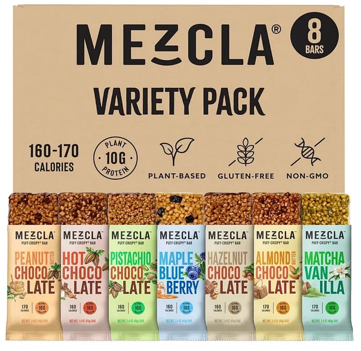 A box of Mezcla protein bars, LMNT electrolyte packets, a bag of Skinny Dipped chocolate almonds, Nespresso pods.