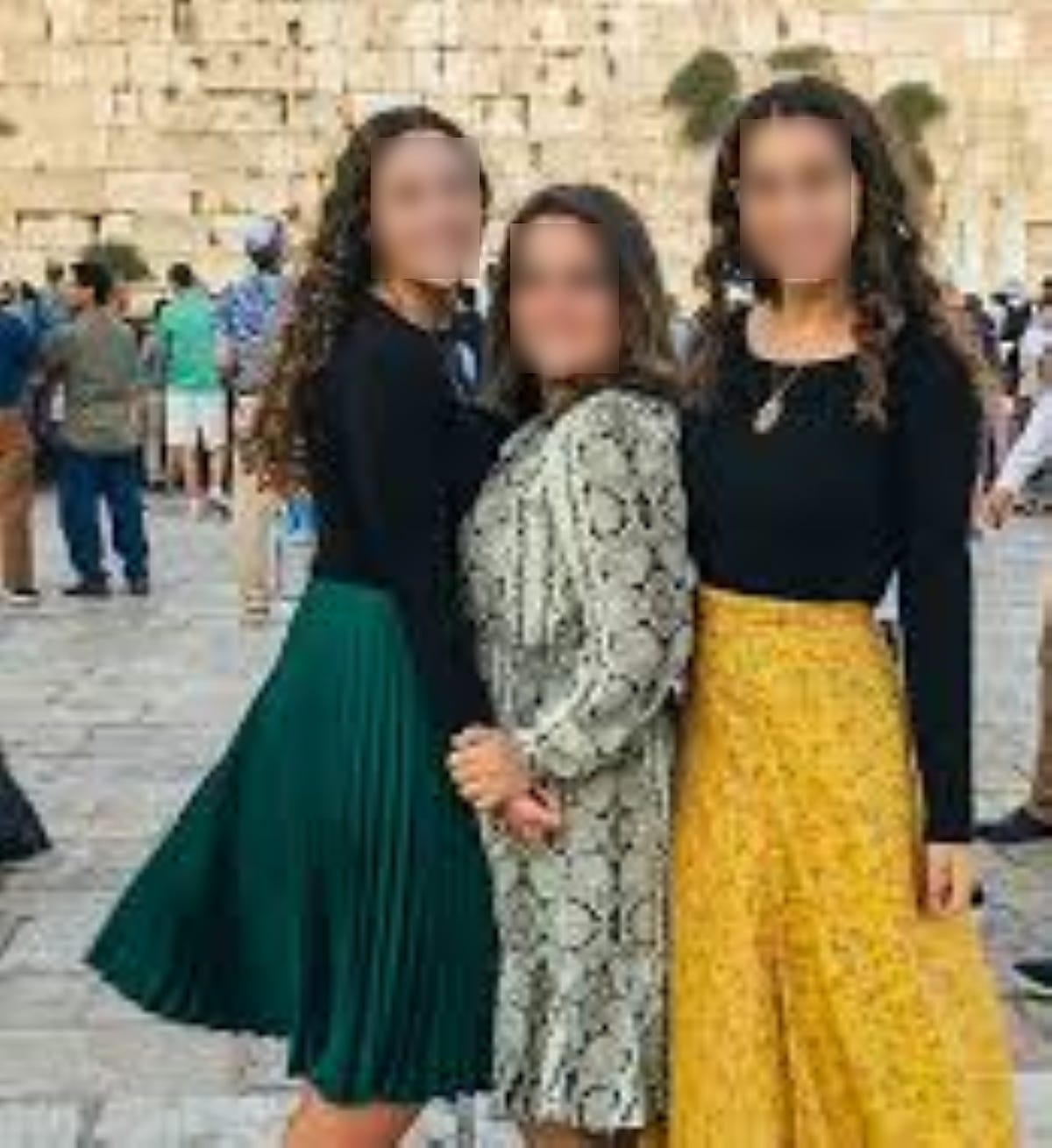 Three girls in attractive modest clothes at the Western Wall in Jerusalem