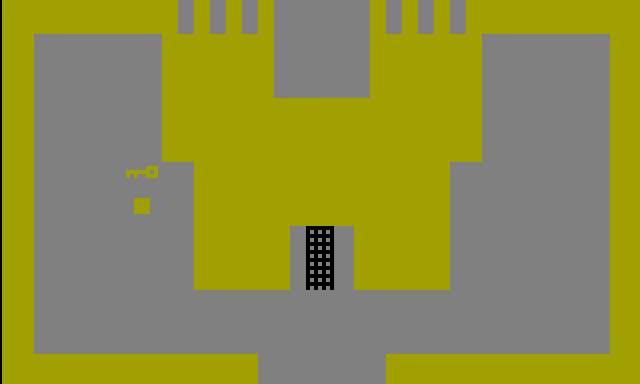 We see a yellow square adjacent to a blocky low res image of a yellow key. The square is a player avatar, and he is standing next to a yellow castle. And by “castle,” I mean a concatenation of 10 or 11 yellow boxes and rectangles of various sizes which kind of resemble a structure with two parapets. There is an iron gate blocking the entrance to the castle, and by “gate” I mean what looks like a spreadsheet column that is three blocks wide and eight blocks high. We see a yellow square adjacent to a blocky low res image of a yellow key. The square is a player avatar, and he is standing next to a yellow castle. And by “castle,” I mean a concatenation of 10 or 11 yellow boxes and rectangles of various sizes which kind of resemble a structure with two parapets. There is an iron gate blocking the entrance to the castle, and by “gate” I mean what looks like a spreadsheet column that is three blocks wide and eight blocks high.