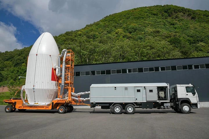 The Long March 4C's first-stage being prepared for the flight, its fairing heading to the launch pad, and it's third-stage and fairing being lifted onto the vehicle.