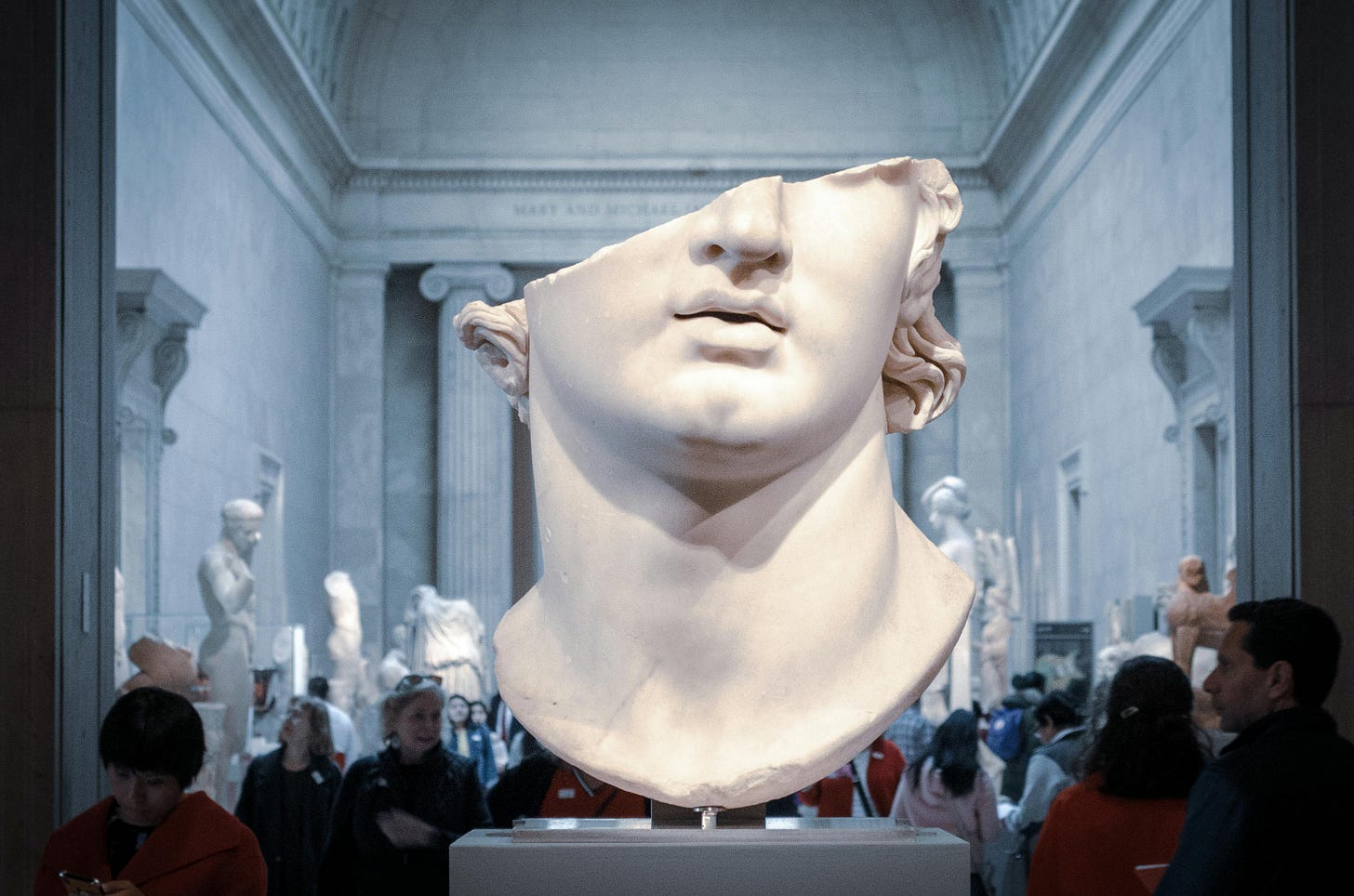 A fragment of a statue bust at a museum.