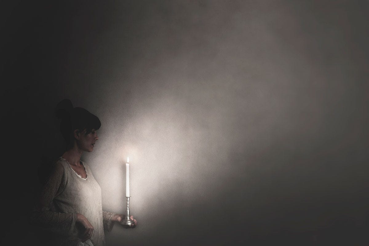 The Courage to Face the Truth; Woman Illuminating Darkness with Candle The Courage to Face the Truth; Woman Illuminating Darkness with Candle