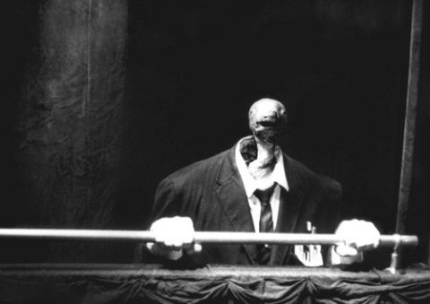 This may contain: a black and white photo of a man in a suit