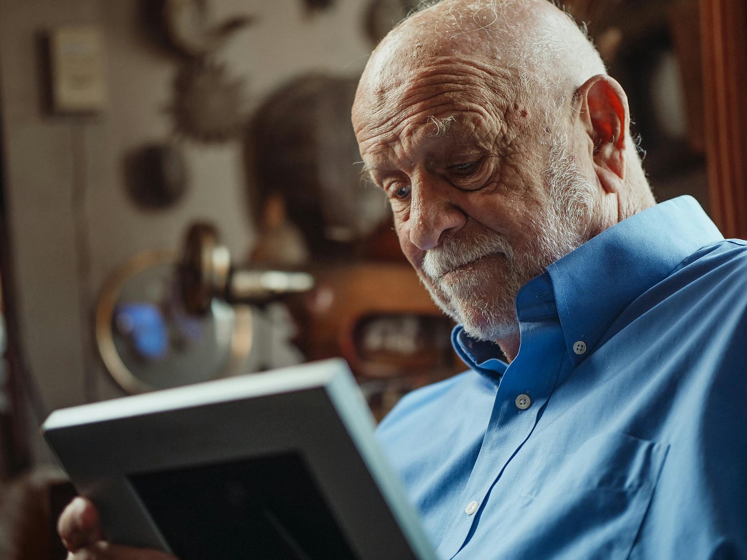 Sad Man Looking At The Picture Frame · Free Stock Photo