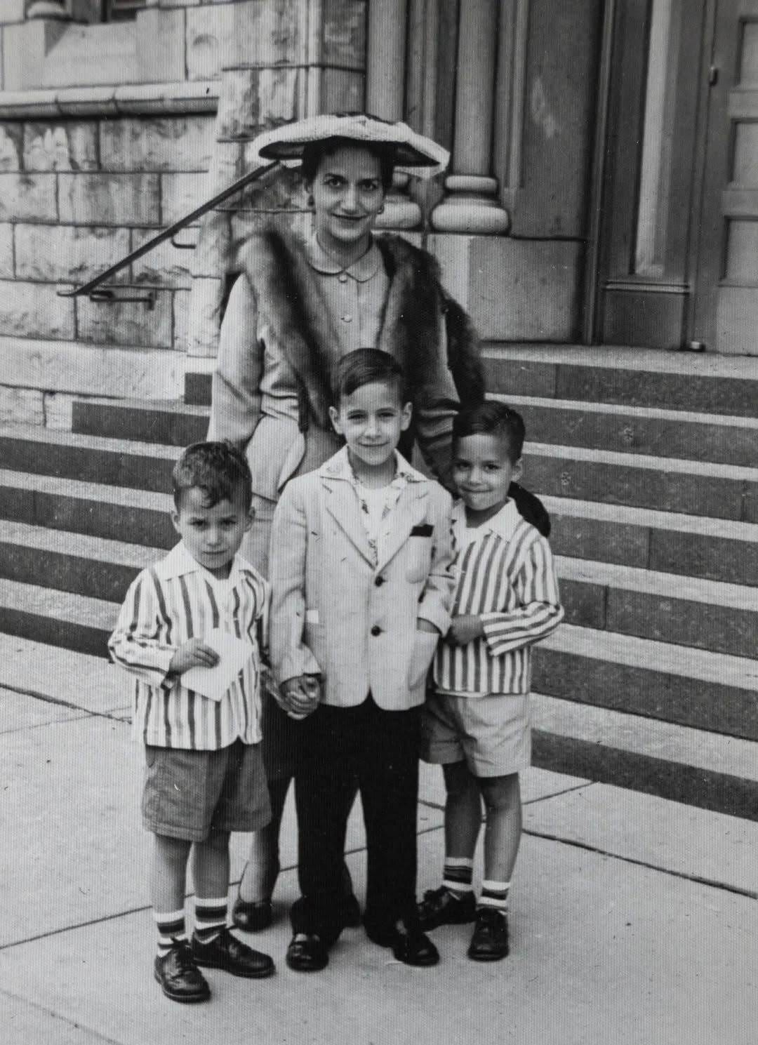May be a black-and-white image of 4 people and child